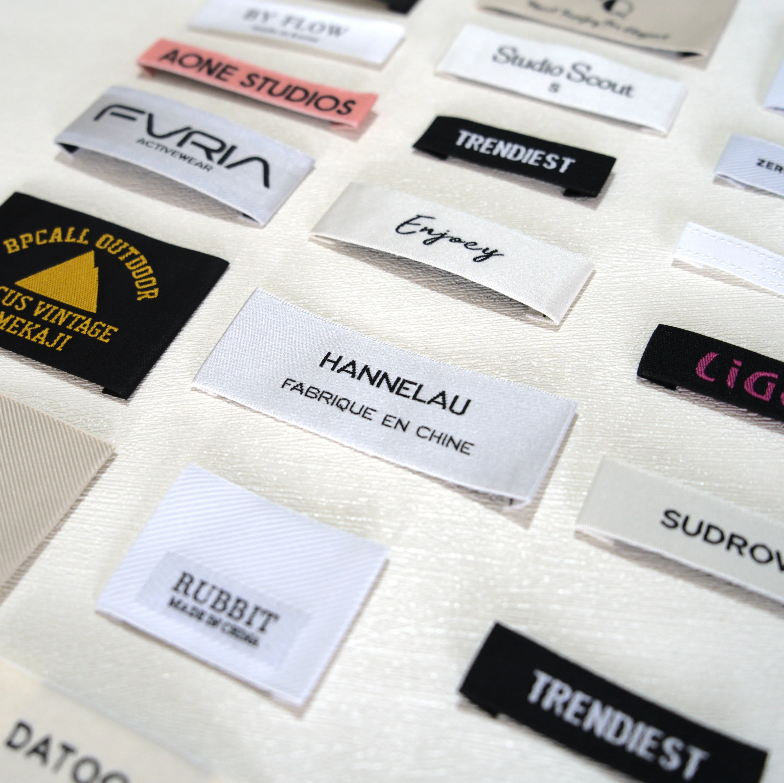 Clothing Labels with Logo: Custom Design & Print Guide 3 Clothing Labels with Logo shown as a UK textile label manufacturing example with hang tag size label and patch label application