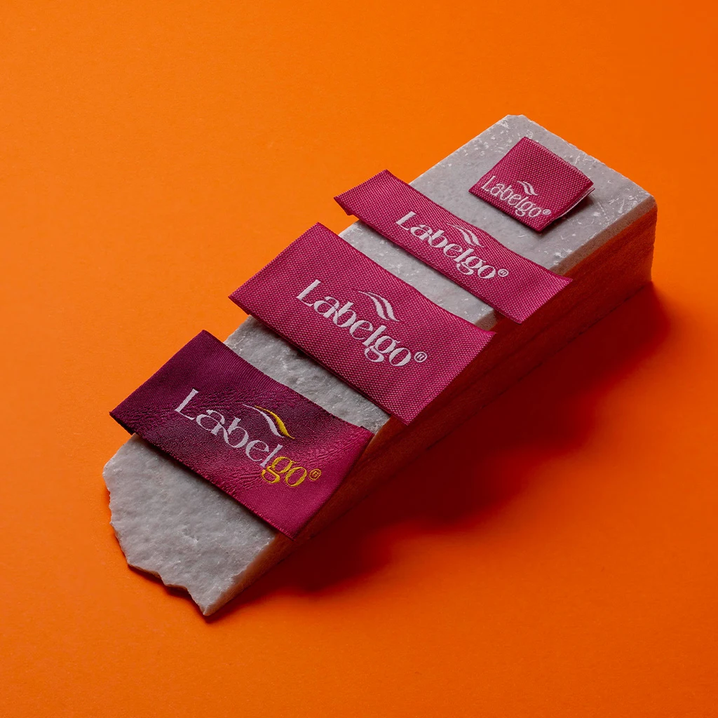 Clothing Labels For Small Businesses: Factory Quality Guide 3 Clothing Labels for Small Businesses shown as a UK textile label manufacturing example with hang tag size label and patch label application