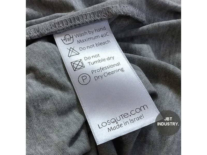 How to Source Custom Care Labels: 2026 Quality Standards 2 Custom Care Labels shown as a UK textile label manufacturing example with printed fabric label and care label